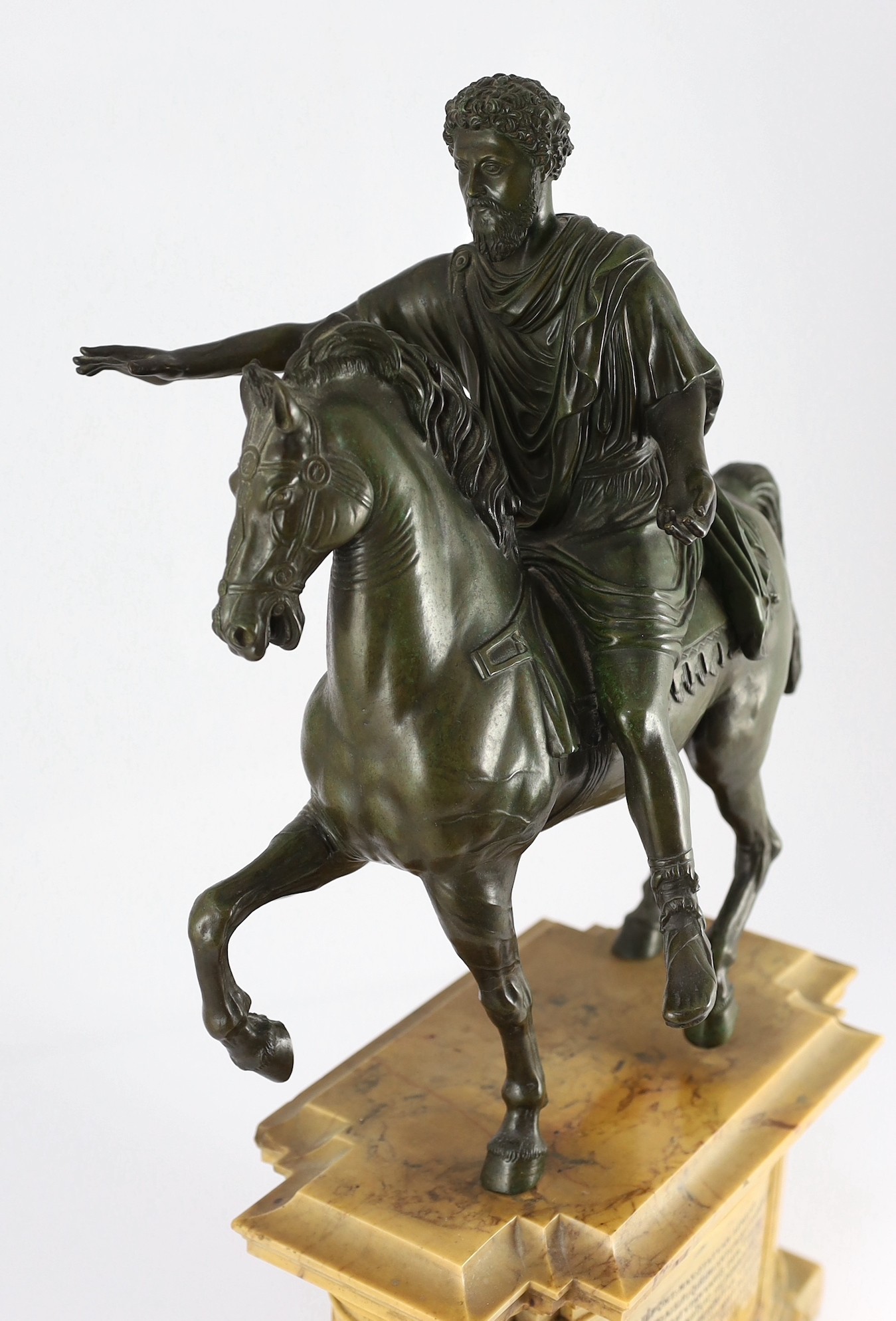 After the Antique. A 19th century Italian Grand Tour bronze equestrian group, modelled as Emperor Marcus Aurelius on horseback, 31cm wide, 16cm deep, overall 57cm high
